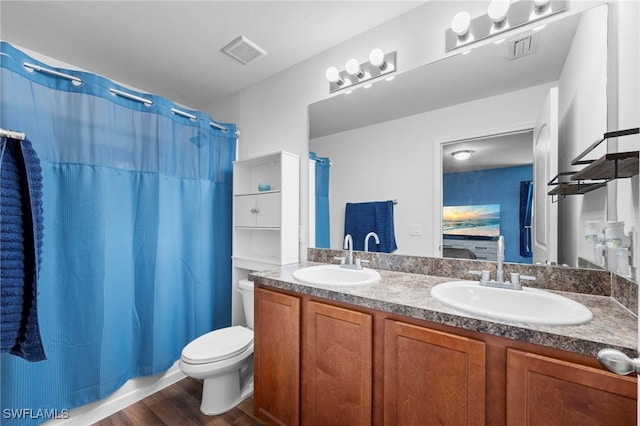 1100 NW 20th St, Cape Coral, FL 33993 - full bathroom featuring double vanity, wood finished floors, and ensuite bath