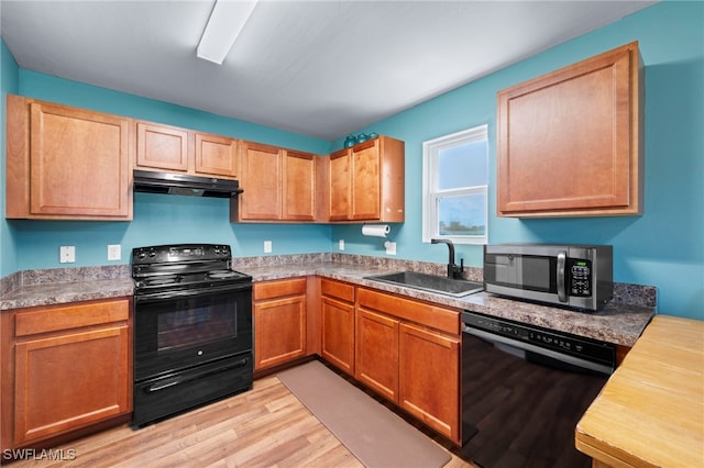 1100 NW 20th St, Cape Coral, FL 33993 - kitchen featuring black appliances, under cabinet range hood, and light wood-type flooring