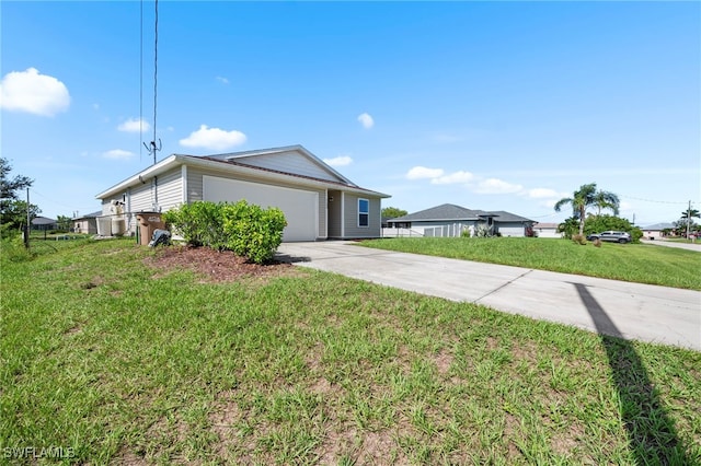 1100 NW 20th St, Cape Coral, FL 33993 - view of side of property with driveway, a garage, and a yard