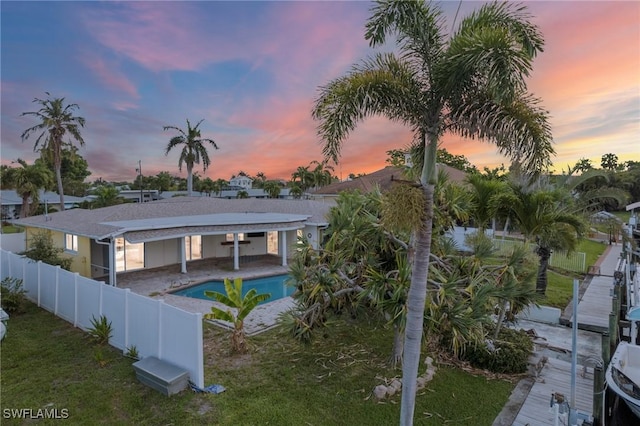 1442 Wellington Ct, Cape Coral, FL 33904 - rear view of house featuring driveway and a patio area