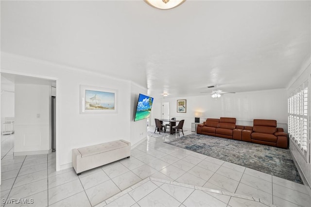 1442 Wellington Ct, Cape Coral, FL 33904 - living room with ceiling fan, wainscoting, and light marble finish floors