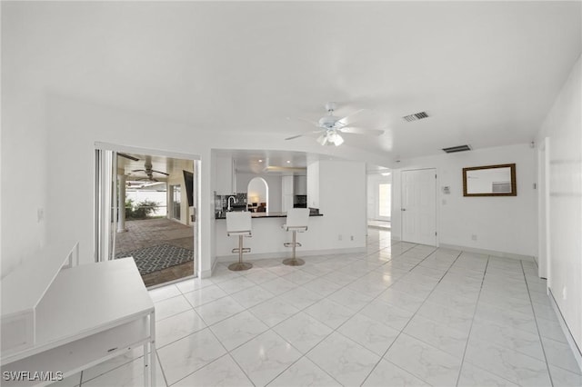 1442 Wellington Ct, Cape Coral, FL 33904 - unfurnished living room featuring a ceiling fan and light marble finish floors