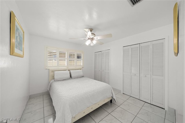 1442 Wellington Ct, Cape Coral, FL 33904 - bedroom featuring light marble finish floors, multiple closets, and a ceiling fan