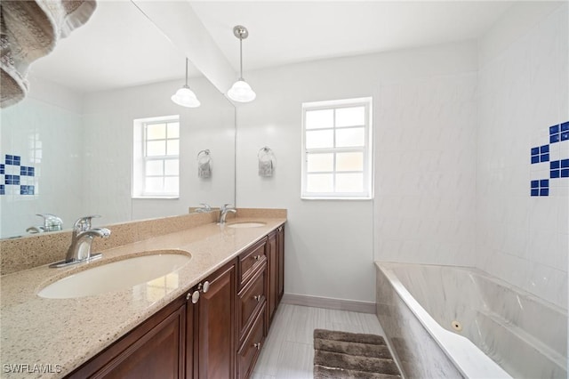 1442 Wellington Ct, Cape Coral, FL 33904 - full bathroom with a tub with jets, double vanity, and tile patterned floors