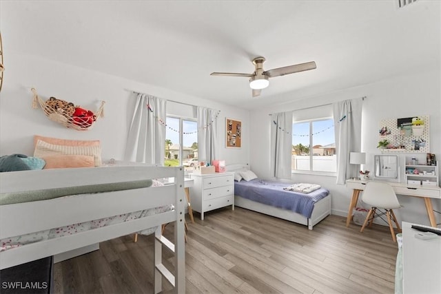 605 SW 18th Ter, Cape Coral, FL 33991 - bedroom with multiple windows, light wood-type flooring, and a ceiling fan