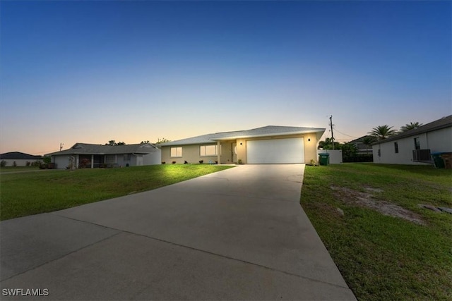605 SW 18th Ter, Cape Coral, FL 33991 - ranch-style house with concrete driveway, a garage, a lawn, and stucco siding