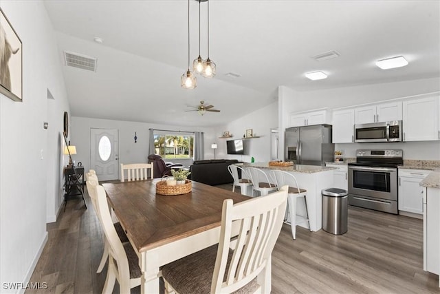 605 SW 18th Ter, Cape Coral, FL 33991 - dining room with lofted ceiling, wood finished floors, and ceiling fan