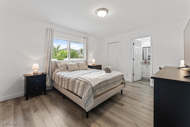 605 SW 18th Ter, Cape Coral, FL 33991 - bedroom with light wood-style floors, ensuite bath, and a closet