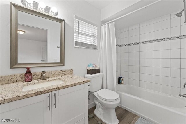605 SW 18th Ter, Cape Coral, FL 33991 - bathroom with vanity, shower / bath combo with shower curtain, and wood finished floors
