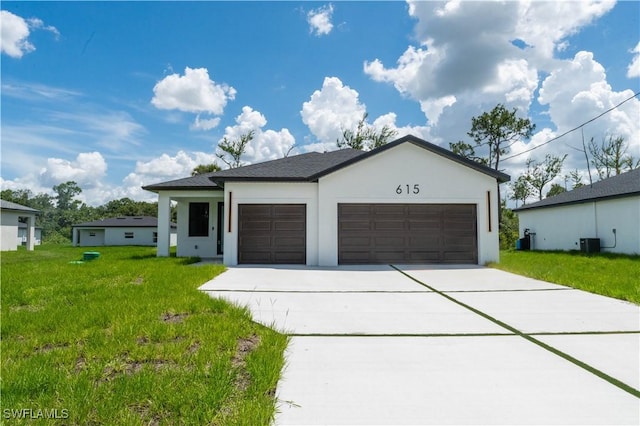615 Greenbriar Blvd, Lehigh Acres, FL 33972 - view of front facade featuring a garage, stucco siding, driveway, and a front lawn