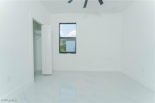 615 Greenbriar Blvd, Lehigh Acres, FL 33972 - unfurnished bedroom featuring marble finish floors, ceiling fan, and a closet
