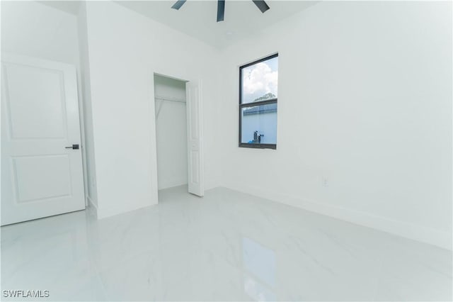 615 Greenbriar Blvd, Lehigh Acres, FL 33972 - unfurnished bedroom with a closet, a ceiling fan, and marble finish flooring