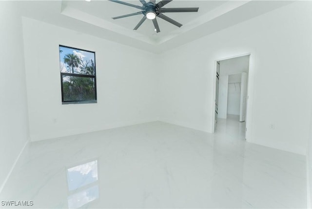615 Greenbriar Blvd, Lehigh Acres, FL 33972 - empty room with a raised ceiling and a ceiling fan