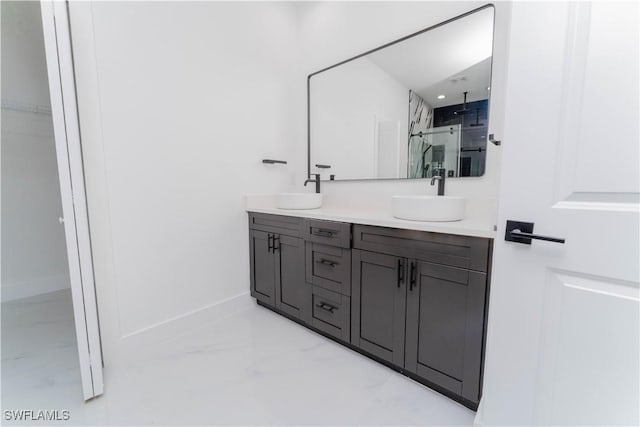 615 Greenbriar Blvd, Lehigh Acres, FL 33972 - full bathroom with marble look tiles, a stall shower, double vanity, and a spacious closet
