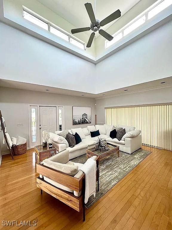 1868 Dogwood Dr, Marco Island, FL 34145 - living area featuring a towering ceiling, a ceiling fan, and light wood-style flooring
