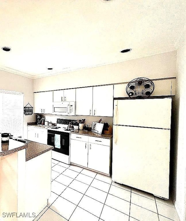 1868 Dogwood Dr, Marco Island, FL 34145 - kitchen with white appliances, dark countertops, white cabinets, light tile patterned floors, and crown molding