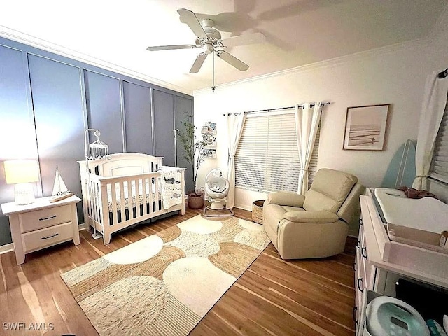 1868 Dogwood Dr, Marco Island, FL 34145 - bedroom featuring wood finished floors, a crib, ornamental molding, and ceiling fan