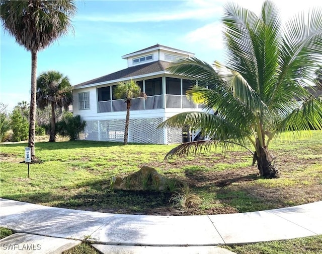 1868 Dogwood Dr, Marco Island, FL 34145 - view of home's exterior featuring a sunroom and a lawn
