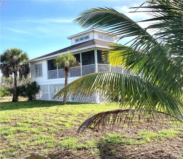 1868 Dogwood Dr, Marco Island, FL 34145 - view of home's exterior featuring a sunroom and a lawn