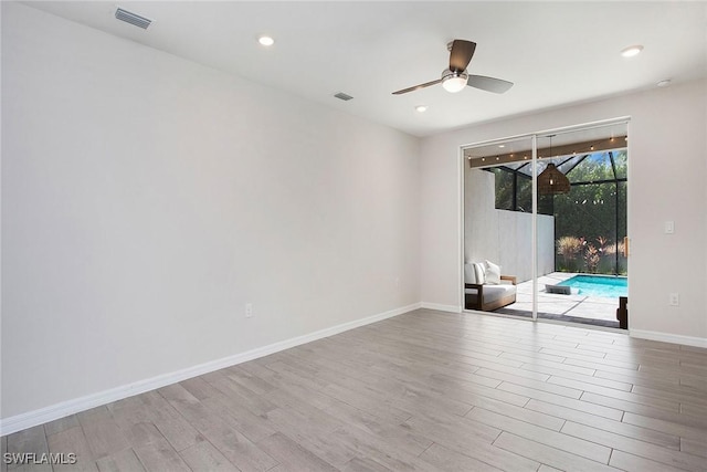 14671 Edgewater Cir, Naples, FL 34114 - spare room with wood finished floors, ceiling fan, and recessed lighting