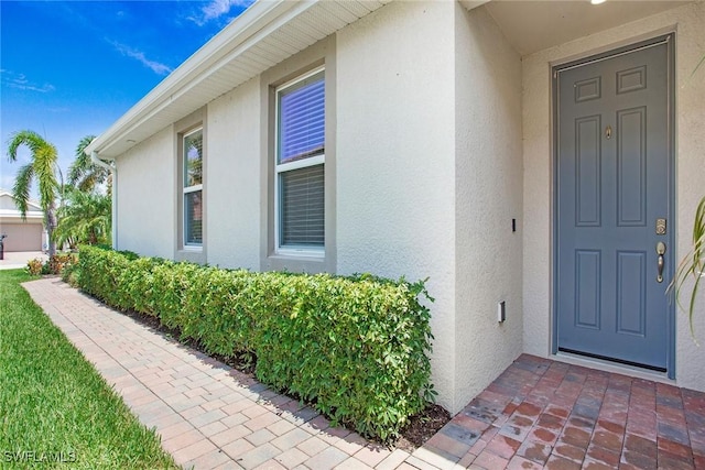 14671 Edgewater Cir, Naples, FL 34114 - property entrance featuring stucco siding