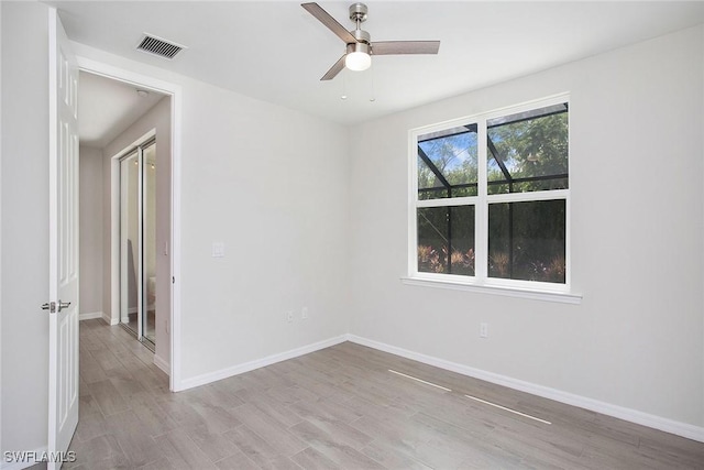 14671 Edgewater Cir, Naples, FL 34114 - unfurnished room featuring wood finished floors and ceiling fan