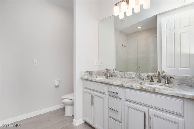 14671 Edgewater Cir, Naples, FL 34114 - full bathroom with double vanity, a shower stall, and wood finished floors