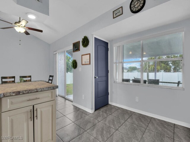 515 SW 9th Ct, Cape Coral, FL 33991 - kitchen featuring ceiling fan, tile patterned floors, lofted ceiling, and light countertops