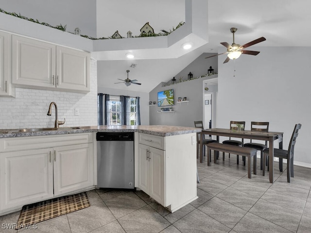 515 SW 9th Ct, Cape Coral, FL 33991 - kitchen with stainless steel dishwasher, ceiling fan, a peninsula, white cabinetry, and high vaulted ceiling