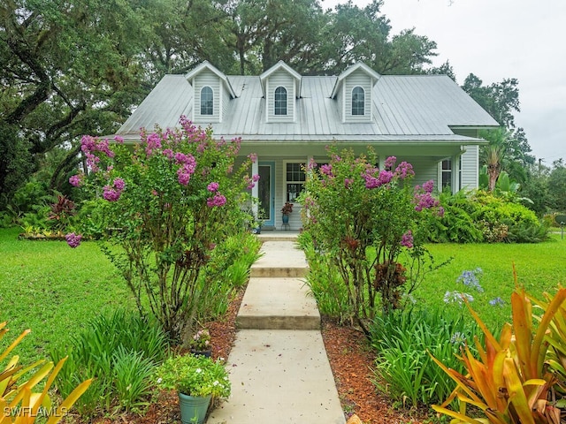 21950 N River Rd, Alva, FL 33920 - cape cod house featuring covered porch and a front yard