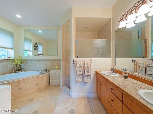 21950 N River Rd, Alva, FL 33920 - bathroom with a garden tub, double vanity, a shower stall, tile patterned floors, and recessed lighting
