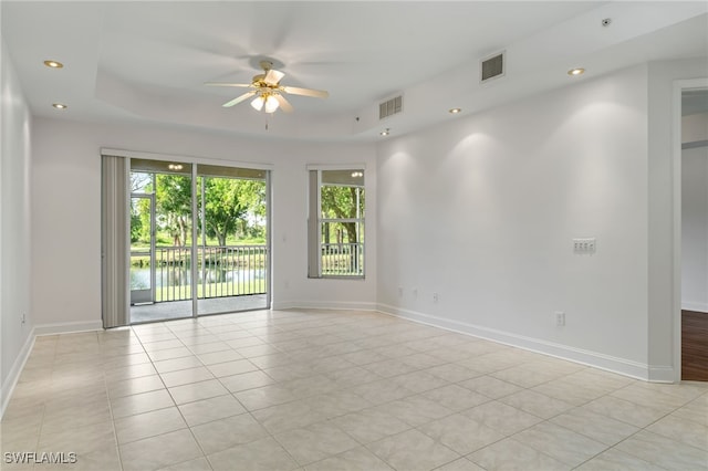 15250 Riverbend Blvd Unit 101, North Fort Myers, FL 33917 - empty room featuring ceiling fan, light tile patterned floors, a tray ceiling, and recessed lighting