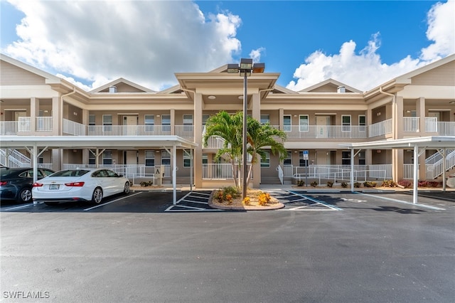 15250 Riverbend Blvd Unit 101, North Fort Myers, FL 33917 - view of building exterior with covered and uncovered parking