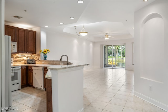 15250 Riverbend Blvd Unit 101, North Fort Myers, FL 33917 - kitchen with white appliances, a peninsula, light tile patterned floors, a ceiling fan, and recessed lighting