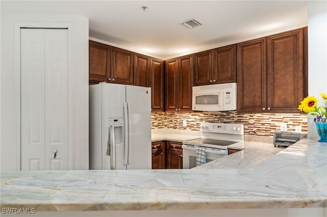15250 Riverbend Blvd Unit 101, North Fort Myers, FL 33917 - kitchen featuring white appliances, light stone countertops, and tasteful backsplash