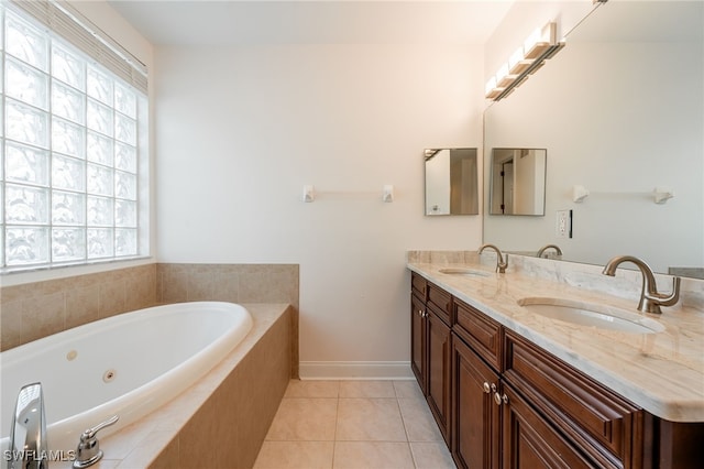 15250 Riverbend Blvd Unit 101, North Fort Myers, FL 33917 - full bath with double vanity, a jetted tub, and tile patterned flooring