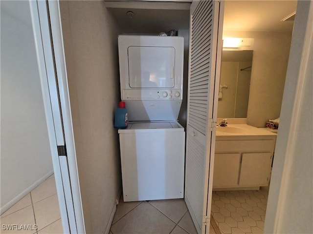 345 Mango St Unit 505, Fort Myers Beach, FL 33931 - laundry room with stacked washer / drying machine and light tile patterned floors