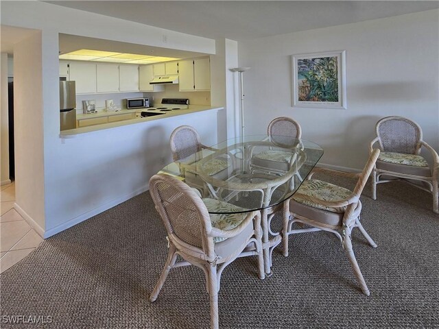345 Mango St Unit 505, Fort Myers Beach, FL 33931 - dining area featuring light carpet and light tile patterned floors