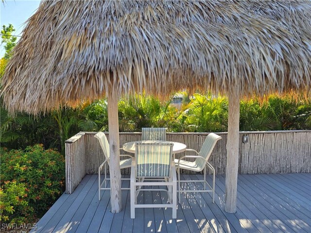 345 Mango St Unit 505, Fort Myers Beach, FL 33931 - wooden terrace featuring outdoor dining area