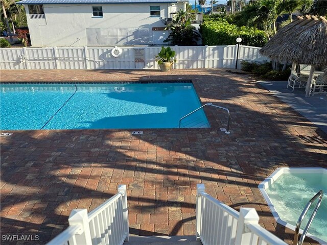 345 Mango St Unit 505, Fort Myers Beach, FL 33931 - community pool featuring a fenced backyard and a patio