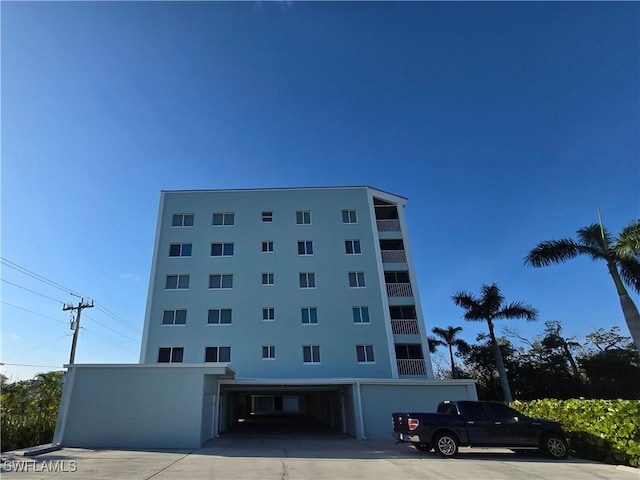 345 Mango St Unit 505, Fort Myers Beach, FL 33931 - view of building exterior with a carport