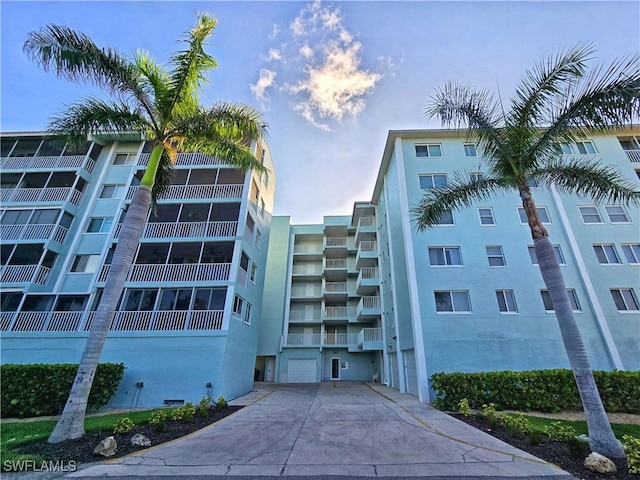 345 Mango St Unit 505, Fort Myers Beach, FL 33931 - view of apartment building / complex with concrete driveway and a garage