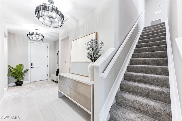19604 Beechcrest Pl, Estero, FL 33928 - stairway with a chandelier