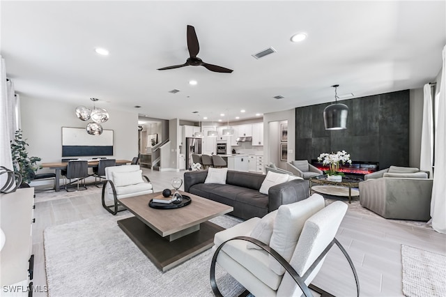 19604 Beechcrest Pl, Estero, FL 33928 - living room with recessed lighting, a ceiling fan, light wood-style flooring, and a chandelier