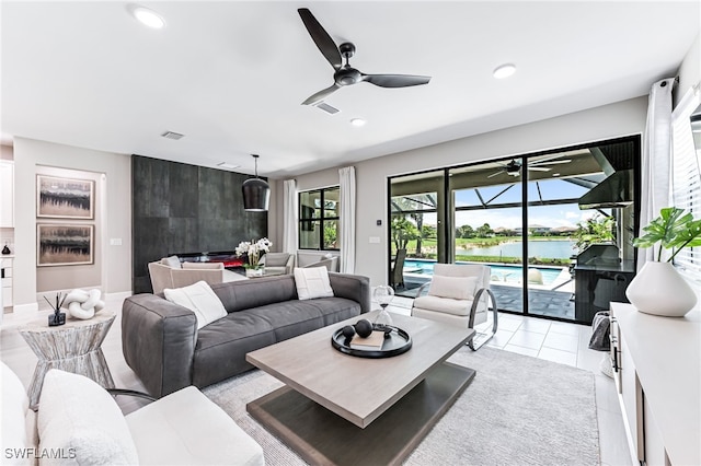 19604 Beechcrest Pl, Estero, FL 33928 - living room with a ceiling fan, a water view, a sunroom, recessed lighting, and light tile patterned floors