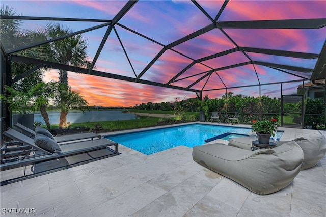 19604 Beechcrest Pl, Estero, FL 33928 - pool at dusk featuring a patio, a water view, an outdoor pool, and glass enclosure