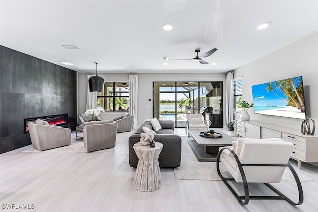 19604 Beechcrest Pl, Estero, FL 33928 - living room with ceiling fan, recessed lighting, and a fireplace