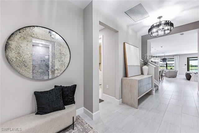 19604 Beechcrest Pl, Estero, FL 33928 - hall featuring a chandelier and baseboards