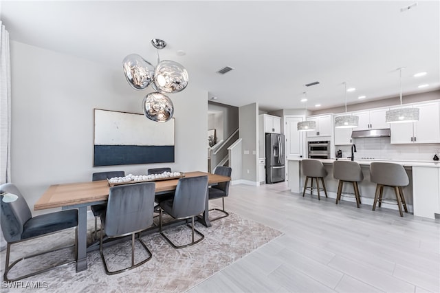 19604 Beechcrest Pl, Estero, FL 33928 - dining area with stairway, recessed lighting, and a chandelier