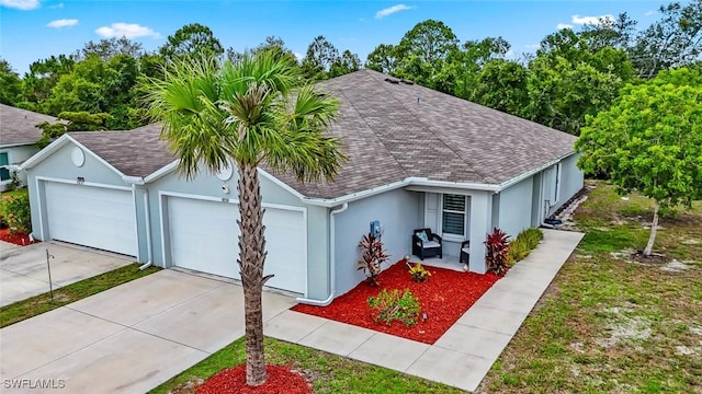 9059 Aegean Cir, Lehigh Acres, FL 33936 - view of front of house featuring stucco siding, a garage, a shingled roof, and concrete driveway
